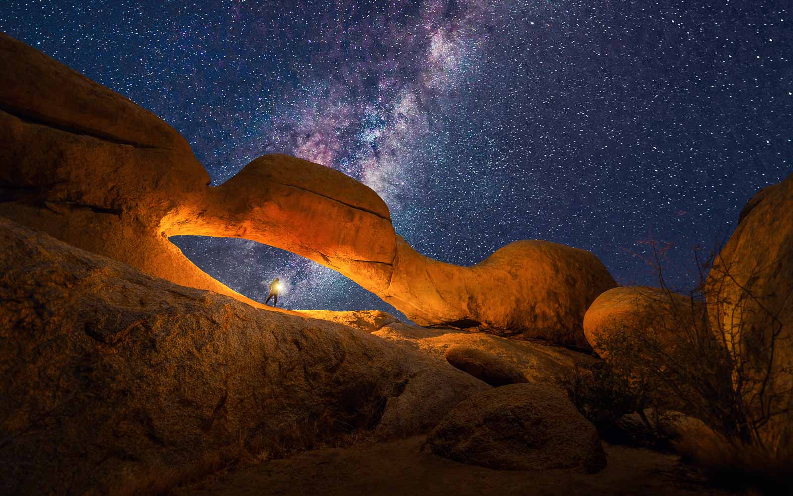 Milky way and stars in red Desert Safari with sand dune in Namibia at night, South Africa. Natural landscape background at sunset time. Famous tourist attraction. Pattern texture of sand. Grand Canyon